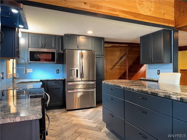 11052 S Lake Rd, Pavilion, NY 14525 - kitchen featuring stainless steel appliances, wooden walls, dark stone countertops, recessed lighting, and extractor fan