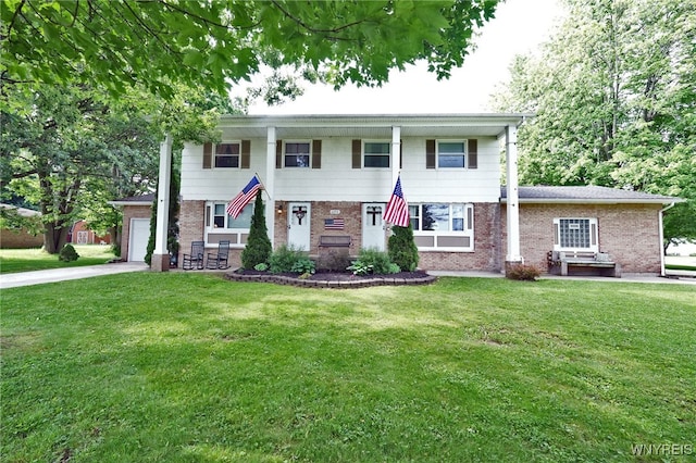 6193 New Taylor Rd, Orchard Park, NY 14127 - view of front of home featuring brick siding, a front lawn, a garage, and concrete driveway