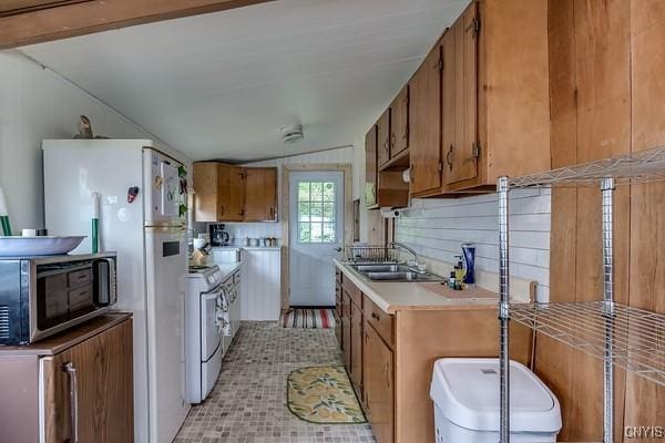 13 Mccabe Rd, Lisbon, NY 13669 - kitchen featuring white appliances, brown cabinetry, light countertops, and light tile patterned floors