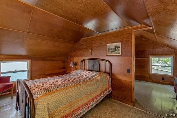 13 Mccabe Rd, Lisbon, NY 13669 - bedroom featuring lofted ceiling, wood walls, and wooden ceiling