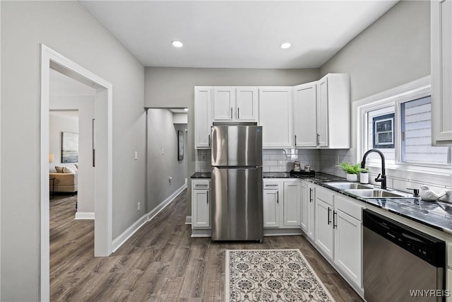 362 W Delavan Ave Unit N, Buffalo, NY 14213 - kitchen with appliances with stainless steel finishes, tasteful backsplash, dark wood-style flooring, dark countertops, and white cabinetry