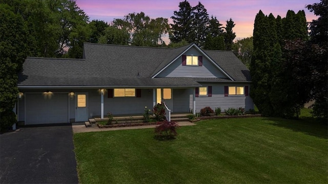 40 Colleen, Henrietta, NY 14534 - view of front of house featuring a garage, asphalt driveway, a front yard, and covered porch