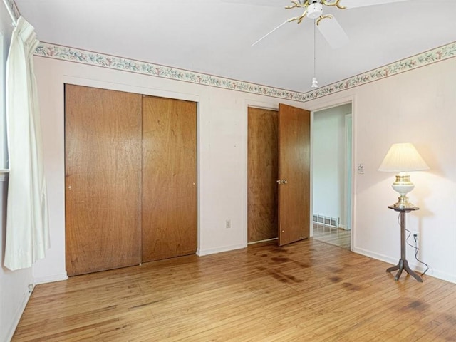 40 Colleen, Henrietta, NY 14534 - unfurnished bedroom with wood finished floors, multiple closets, and ceiling fan