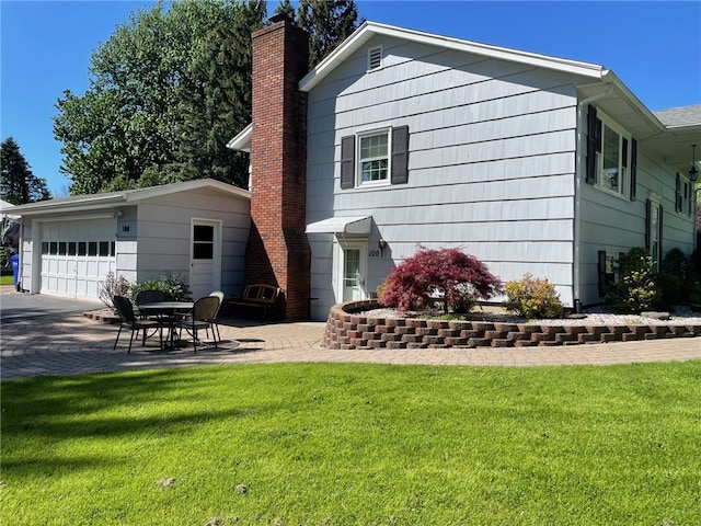 100 Huffer Rd, Parma, NY 14468 - rear view of house featuring a yard, a chimney, an outdoor structure, and a patio area