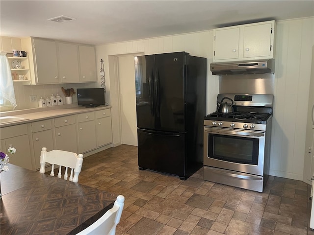 100 Huffer Rd, Parma, NY 14468 - kitchen with freestanding refrigerator, ventilation hood, stainless steel range with gas cooktop, light countertops, and white cabinets