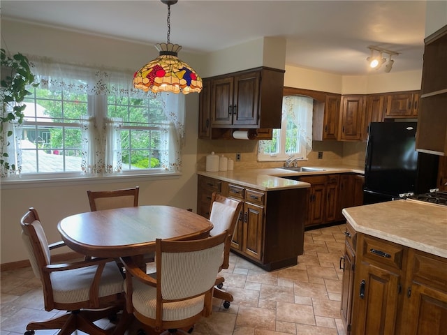100 Huffer Rd, Parma, NY 14468 - kitchen with freestanding refrigerator, light countertops, light stone finish floors, pendant lighting, and a peninsula