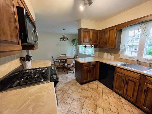 100 Huffer Rd, Parma, NY 14468 - kitchen featuring black appliances, light countertops, light stone finish floors, a peninsula, and hanging light fixtures