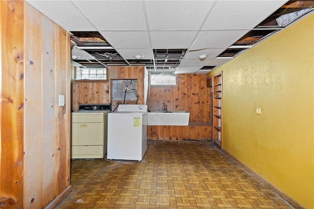 39 Scotch Ln, Irondequoit, NY 14617 - laundry area featuring wood walls and washer and dryer
