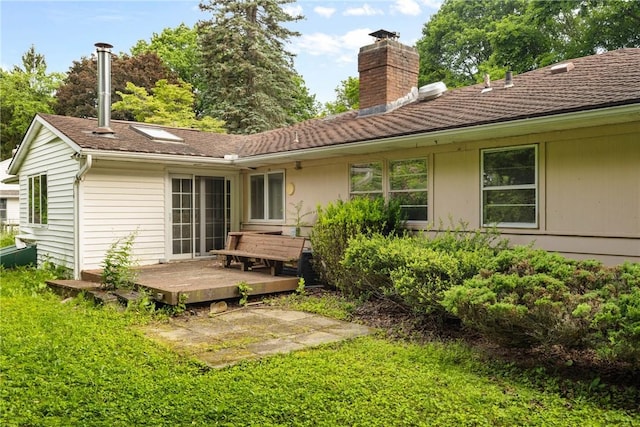 39 Scotch Ln, Irondequoit, NY 14617 - back of property with a wooden deck, a chimney, and a yard