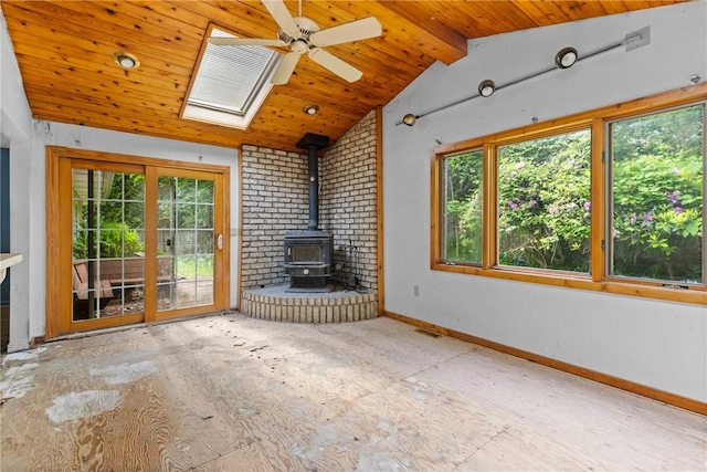 39 Scotch Ln, Irondequoit, NY 14617 - unfurnished living room with a wood stove, healthy amount of natural light, wooden ceiling, ceiling fan, and a skylight