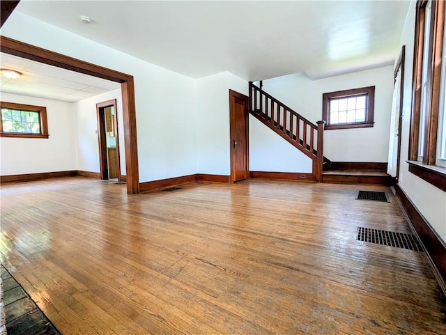 64 Saint Jacob St, Rochester, NY 14621 - unfurnished living room with hardwood / wood-style floors and stairway