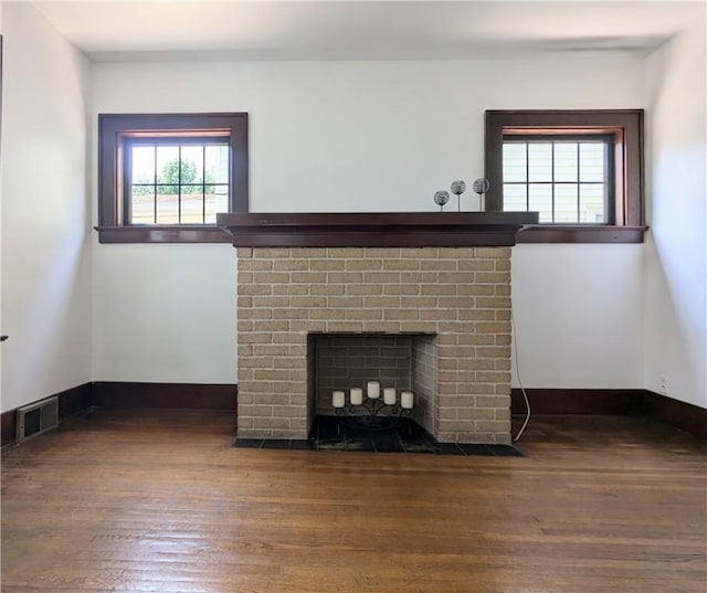 64 Saint Jacob St, Rochester, NY 14621 - unfurnished living room featuring a brick fireplace and wood finished floors