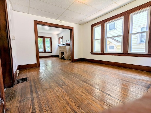 64 Saint Jacob St, Rochester, NY 14621 - unfurnished living room featuring wood-type flooring, a drop ceiling, and a fireplace