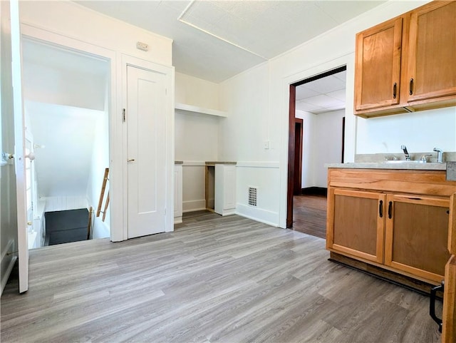 64 Saint Jacob St, Rochester, NY 14621 - kitchen with light wood-type flooring, brown cabinetry, and light countertops