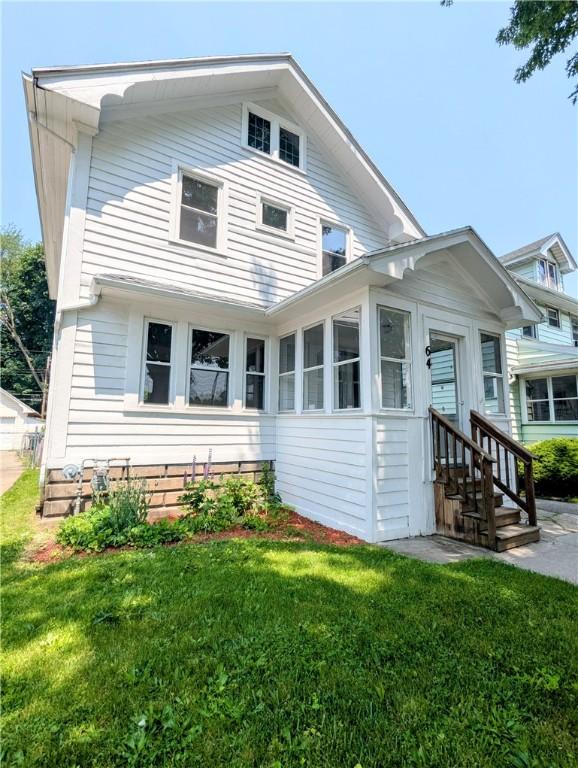 64 Saint Jacob St, Rochester, NY 14621 - view of front of property with a front lawn, a sunroom, and entry steps