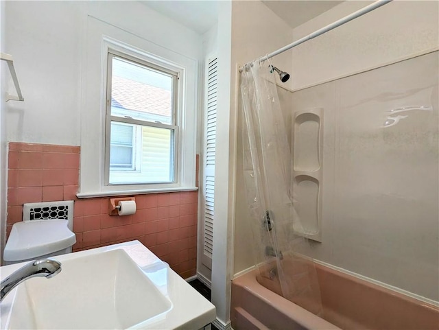 64 Saint Jacob St, Rochester, NY 14621 - bathroom with tile walls, shower / bath combo, and wainscoting