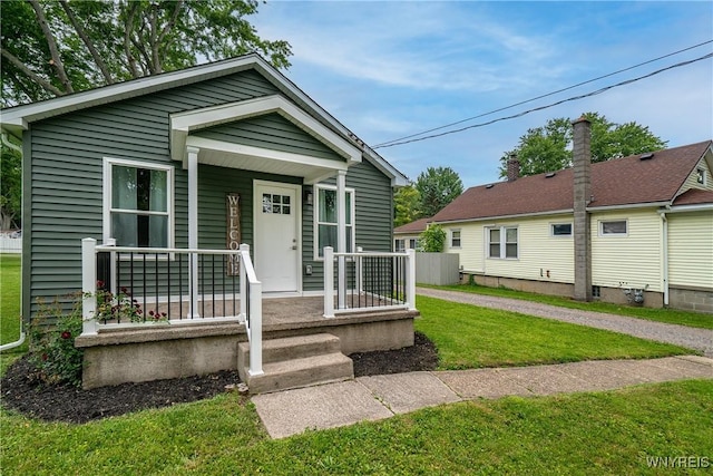 365 Oakdale Dr, North Tonawanda, NY 14120 - view of front facade with a front yard and a porch