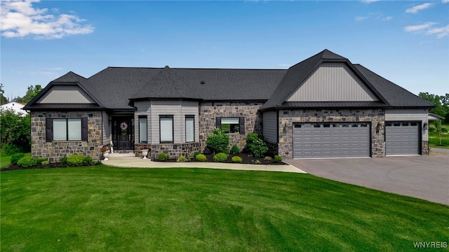 5815 Newhouse Rd, Clarence, NY 14051 - view of front of property featuring stone siding, a front lawn, asphalt driveway, a garage, and board and batten siding