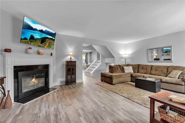 1202 Netherton Ct, Amherst, NY 14051 - living room with wood finished floors, stairway, and a glass covered fireplace