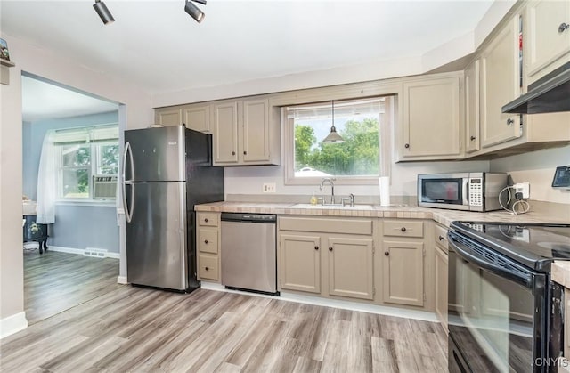 7042 Forbes Rd, Lenox, NY 13032 - kitchen featuring appliances with stainless steel finishes, light countertops, light wood-type flooring, and plenty of natural light