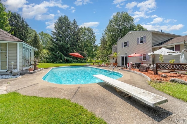 7042 Forbes Rd, Lenox, NY 13032 - swimming pool featuring a patio, a diving board, and a yard