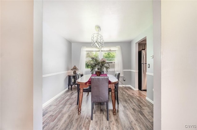 7042 Forbes Rd, Lenox, NY 13032 - dining space featuring a chandelier, light wood-style floors, and cooling unit