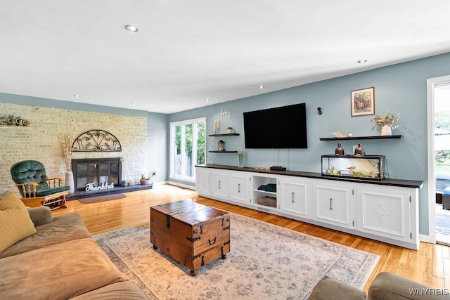 212 Crestwood Ln, Amherst, NY 14221 - living room featuring recessed lighting, light wood-style flooring, and a brick fireplace