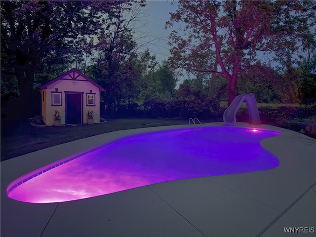 212 Crestwood Ln, Amherst, NY 14221 - swimming pool with a water slide, an outbuilding, and a patio