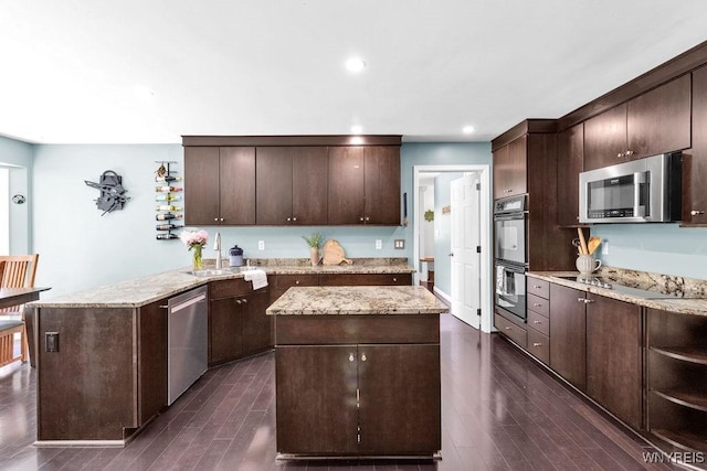 212 Crestwood Ln, Amherst, NY 14221 - kitchen featuring black appliances, dark wood finished floors, a center island, dark brown cabinets, and recessed lighting