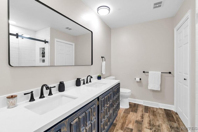 212 Crestwood Ln, Amherst, NY 14221 - bathroom featuring double vanity, wood finished floors, and a tile shower