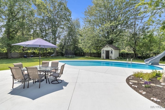 212 Crestwood Ln, Amherst, NY 14221 - view of pool with a water slide, a trampoline, a patio, and a fenced backyard