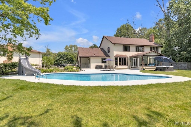 212 Crestwood Ln, Amherst, NY 14221 - view of swimming pool featuring a water slide, a hot tub, and a patio area