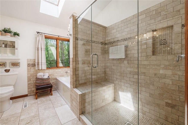 679 Galleon Dr, Webster, NY 14580 - full bathroom featuring a skylight, a garden tub, a shower stall, and tile patterned floors