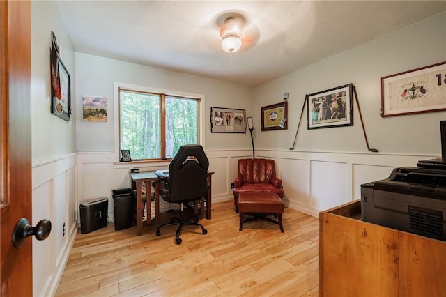 679 Galleon Dr, Webster, NY 14580 - home office featuring a wainscoted wall, light wood-style flooring, and a decorative wall
