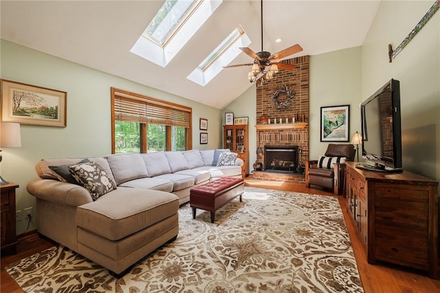 679 Galleon Dr, Webster, NY 14580 - living area with wood finished floors, ceiling fan, a skylight, a fireplace, and high vaulted ceiling