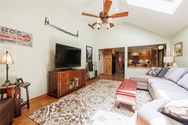 679 Galleon Dr, Webster, NY 14580 - living room with ceiling fan, a skylight, wood finished floors, high vaulted ceiling, and recessed lighting