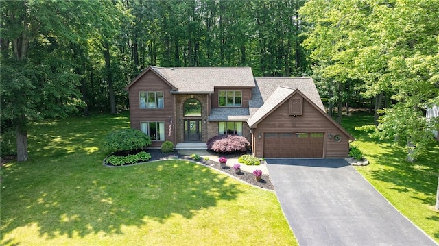 679 Galleon Dr, Webster, NY 14580 - view of front of home with driveway, a front lawn, a shingled roof, and an attached garage