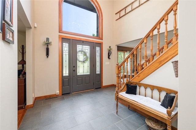 679 Galleon Dr, Webster, NY 14580 - entrance foyer featuring a towering ceiling, tile patterned floors, and stairs
