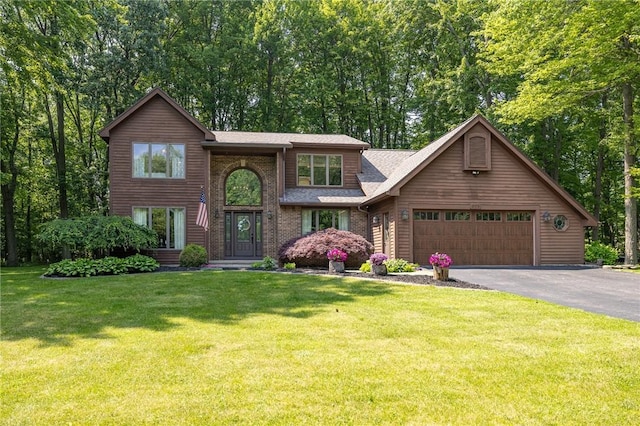 679 Galleon Dr, Webster, NY 14580 - view of front of home featuring driveway, an attached garage, a front yard, and roof with shingles