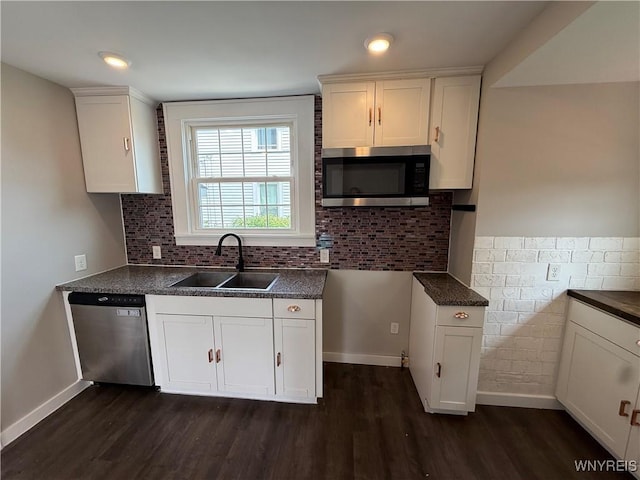17 Orchard Ave, Evans, NY 14006 - kitchen with stainless steel appliances, dark wood-type flooring, dark countertops, white cabinets, and tasteful backsplash