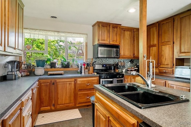 10066 Point Rock Rd, Lee, NY 13440 - kitchen with stainless steel microwave, range with gas stovetop, tasteful backsplash, brown cabinets, and recessed lighting