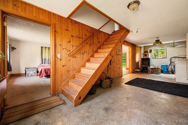 10066 Point Rock Rd, Lee, NY 13440 - staircase with wooden walls, carpet, washer / dryer, and a textured ceiling