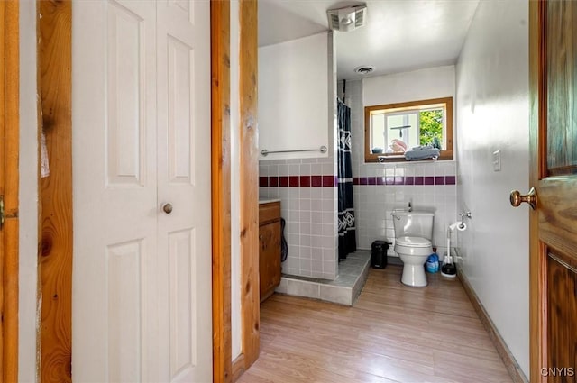 10066 Point Rock Rd, Lee, NY 13440 - full bathroom with wood finished floors, tile walls, and curtained shower