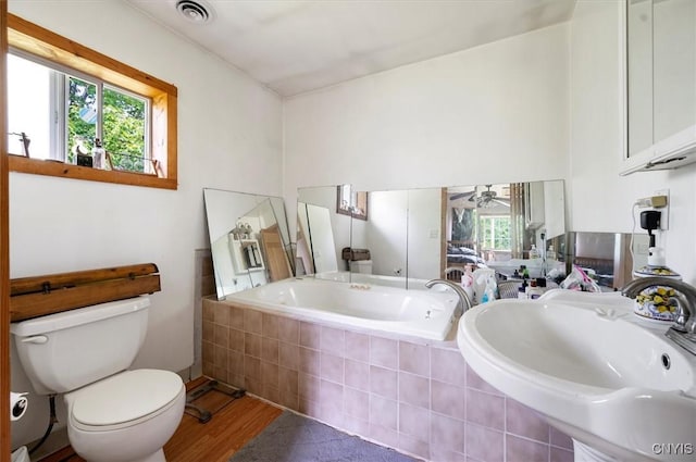 10066 Point Rock Rd, Lee, NY 13440 - bathroom with wood finished floors, a garden tub, and a ceiling fan