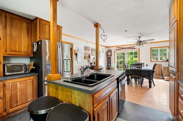 10066 Point Rock Rd, Lee, NY 13440 - kitchen featuring appliances with stainless steel finishes, a ceiling fan, brown cabinetry, dark wood-style floors, and dark countertops