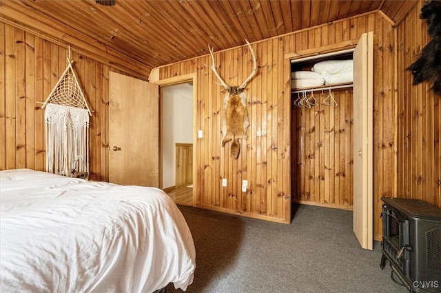 10066 Point Rock Rd, Lee, NY 13440 - carpeted bedroom featuring a wood stove, wooden ceiling, wood walls, a closet, and a walk in closet