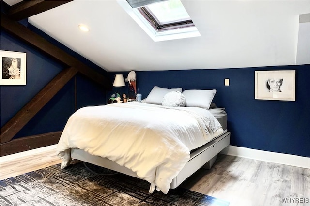 125 Edward St Unit 3I, Buffalo, NY 14201 - bedroom featuring a skylight, vaulted ceiling, and wood finished floors
