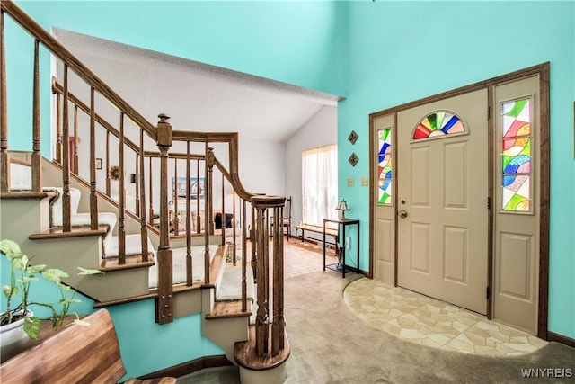 3851 Upper Mountain Rd, Cambria, NY 14132 - foyer featuring stairs, carpet floors, and vaulted ceiling