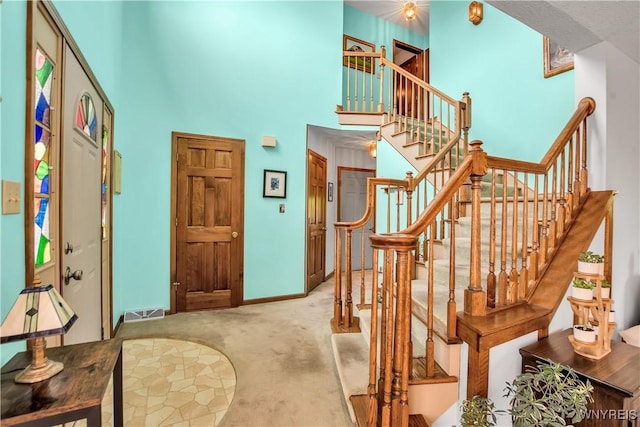 3851 Upper Mountain Rd, Cambria, NY 14132 - stairs featuring carpet and a towering ceiling
