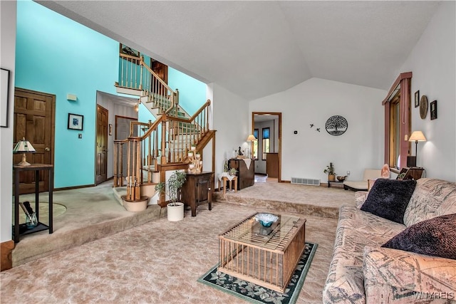 3851 Upper Mountain Rd, Cambria, NY 14132 - carpeted living room featuring stairs and high vaulted ceiling